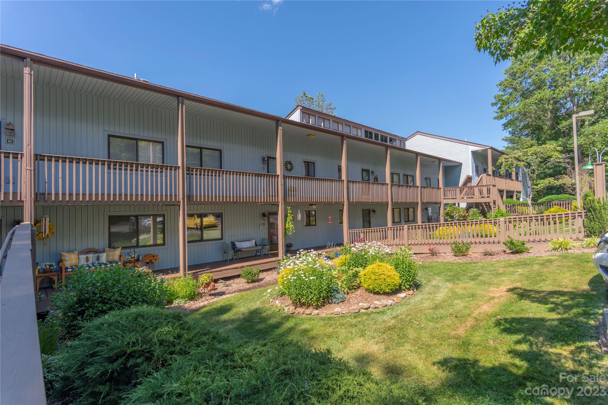87 Willow Road, Unit D12 Waynesville, NC 28786 - Photo 1 of 21 a view of a house with pool and garden