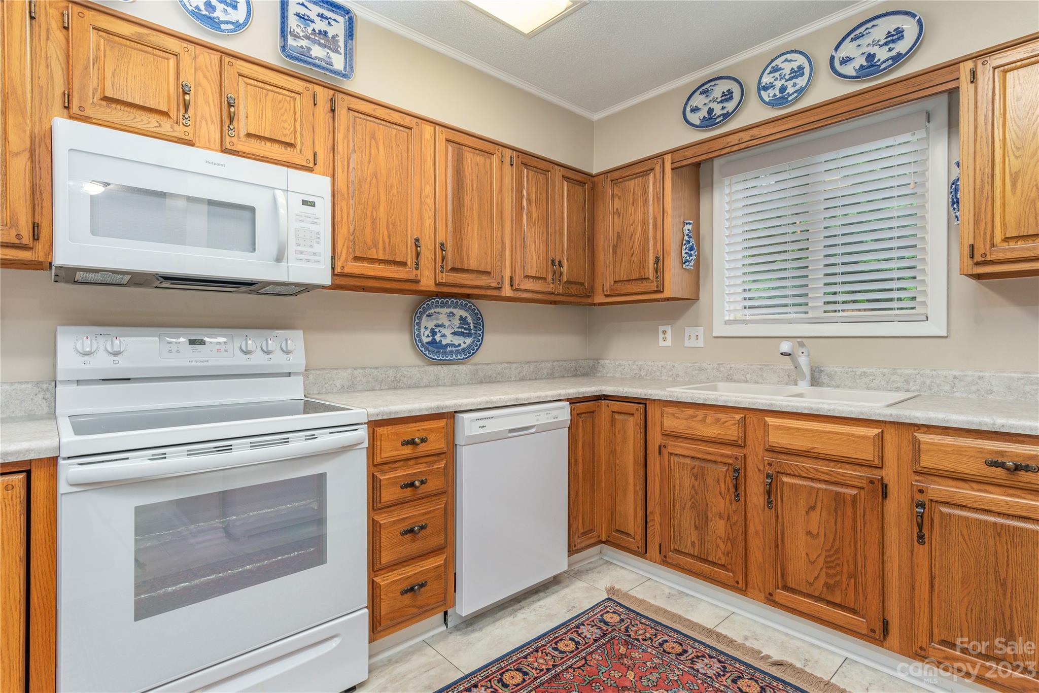 87 Willow Road, Unit D12 Waynesville, NC 28786 - Photo 11 of 21 a kitchen with granite countertop cabinets stainless steel appliances and a sink
