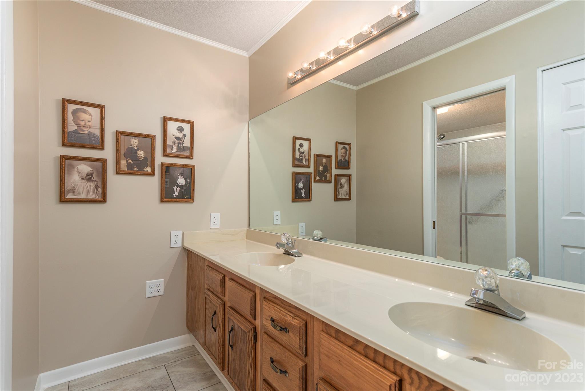 87 Willow Road, Unit D12 Waynesville, NC 28786 - Photo 14 of 21 a bathroom with a double vanity sink and a mirror