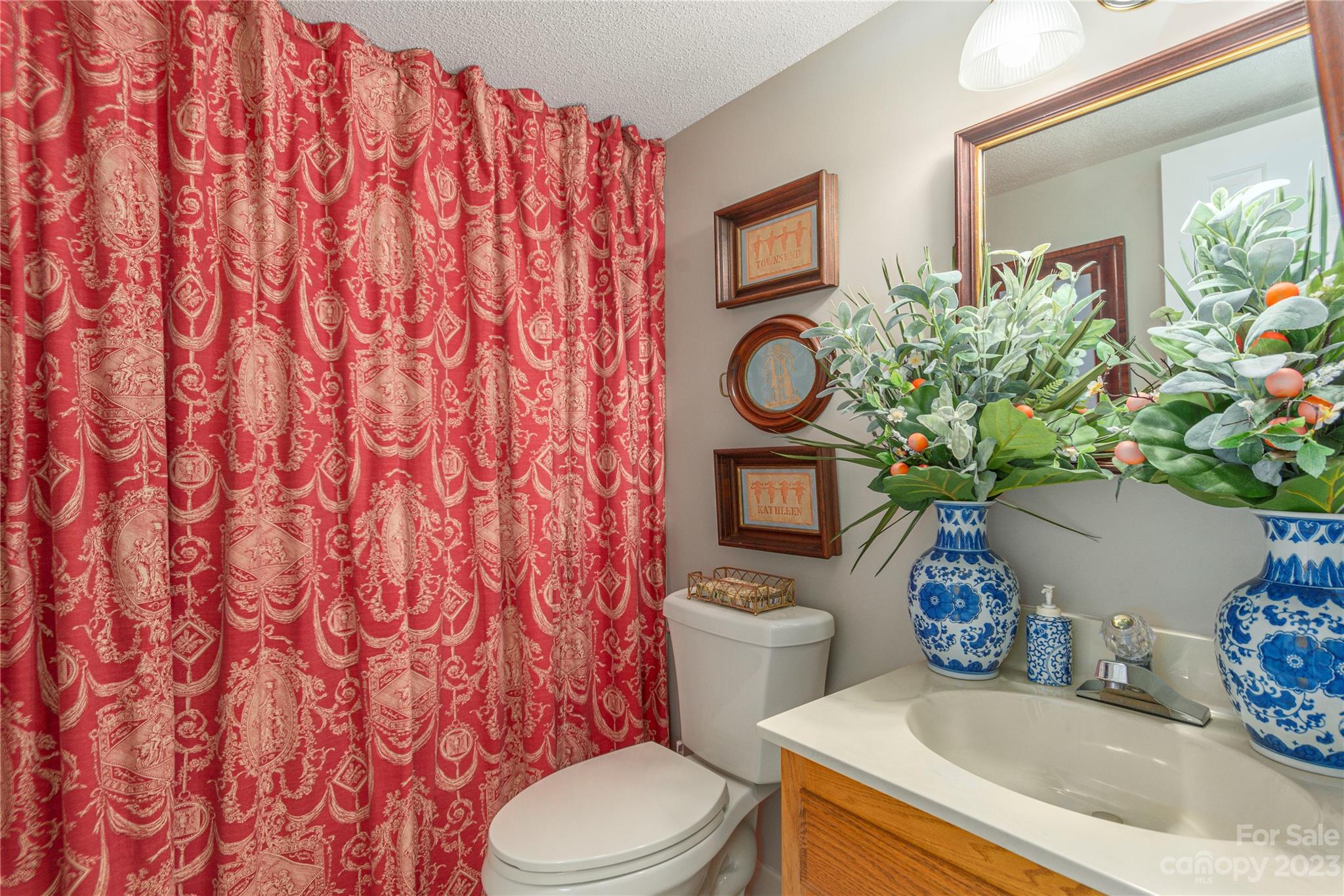 87 Willow Road, Unit D12 Waynesville, NC 28786 - Photo 16 of 21 a white toilet sitting next to a sink and a shower curtain