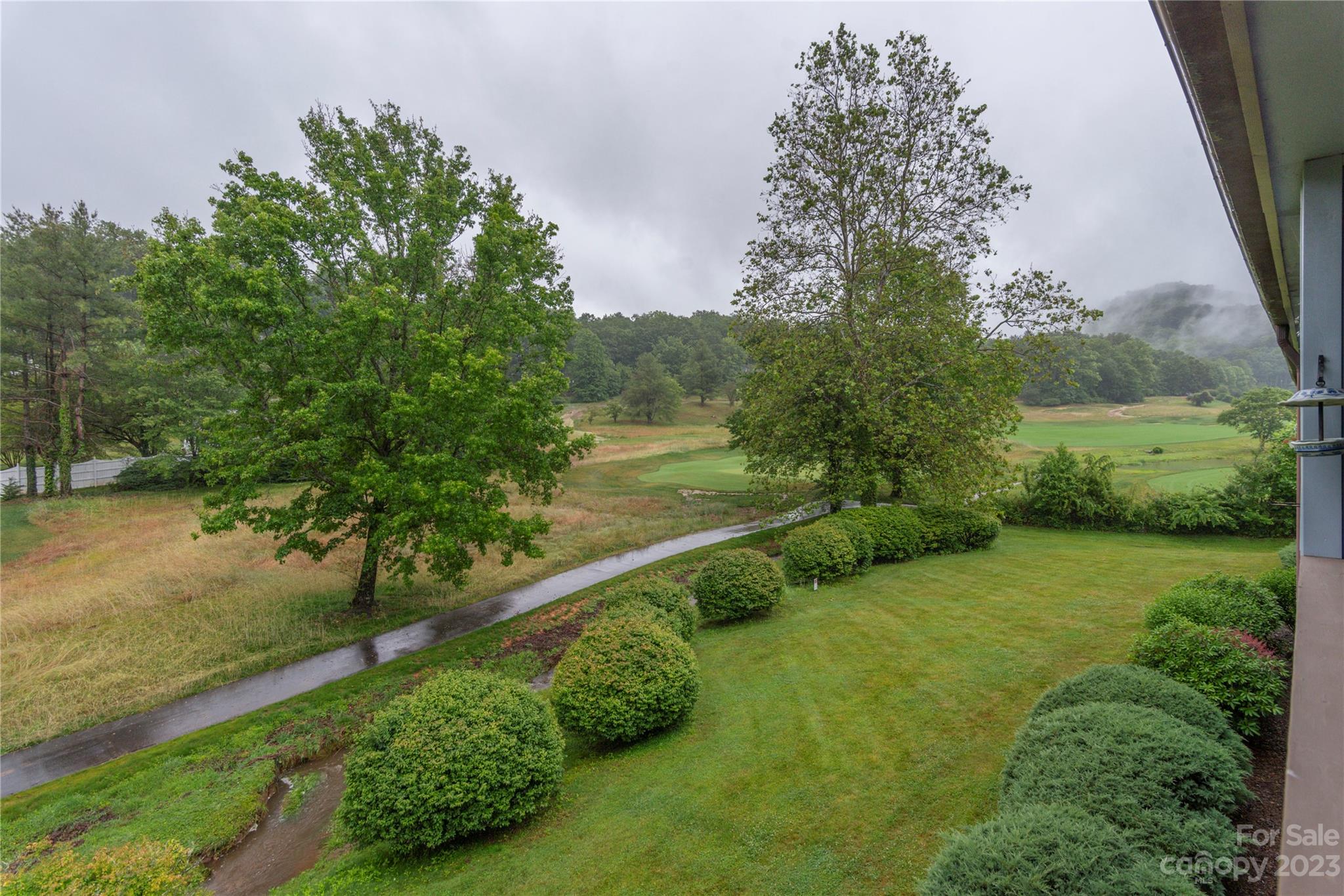 87 Willow Road, Unit D12 Waynesville, NC 28786 - Photo 3 of 21 a view of a garden with an outdoor space