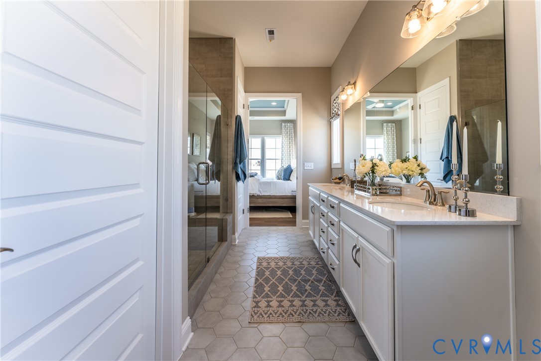 972 Landon Laurel Lane Midlothian, VA 23114 - Photo 28 of 49 a bathroom with a double vanity sink and a mirror