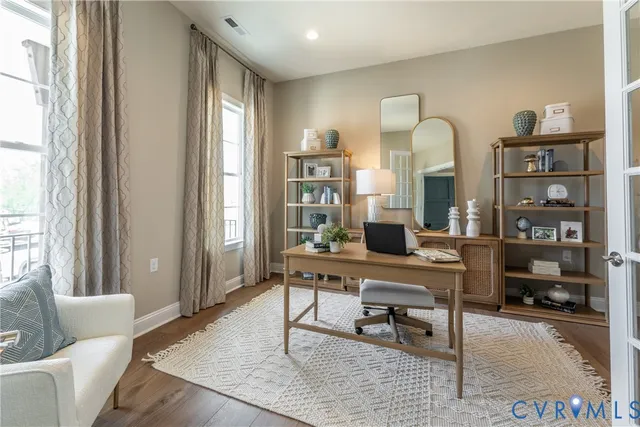 a living room with furniture and a mirror