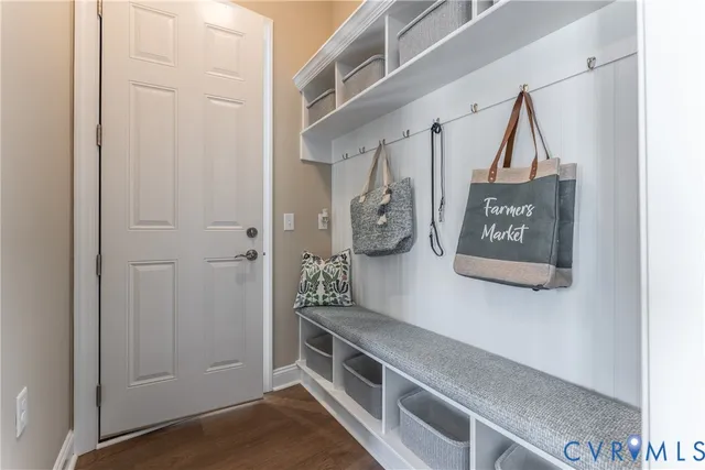 a kitchen with kitchen island granite countertop a sink cabinets and wooden floor