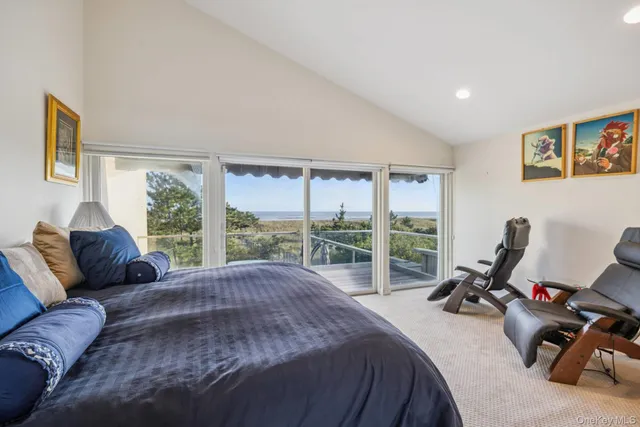 a living room with furniture a flat screen tv and large windows