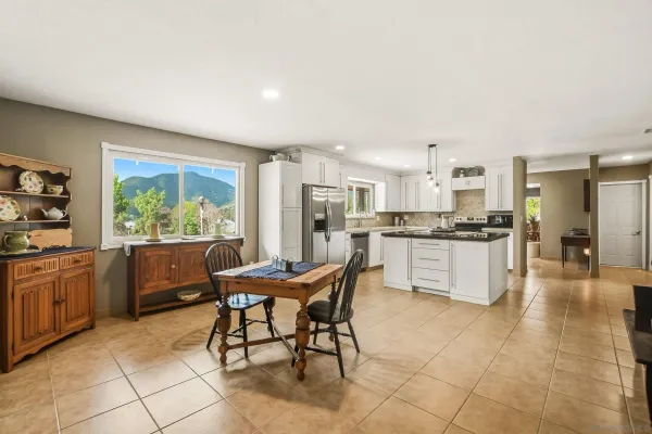 a kitchen with stainless steel appliances kitchen island granite countertop a stove a sink a counter top space and cabinets