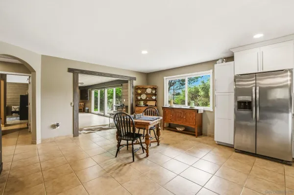 a view of a livingroom with furniture and a refrigerator