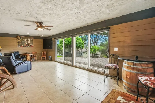 a living room with furniture and a floor to ceiling window