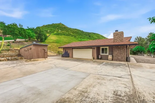 a front view of a house with a garden and yard