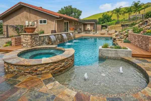 a view of a house with backyard and sitting area