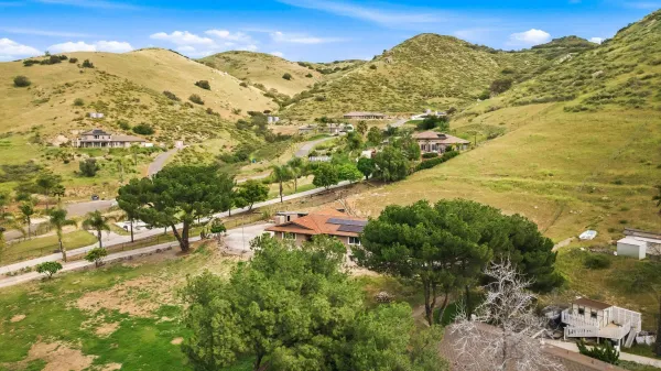 an aerial view of a house with a yard