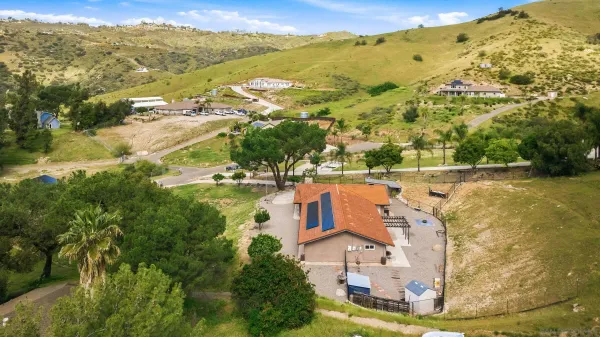 an aerial view of a house with mountain view