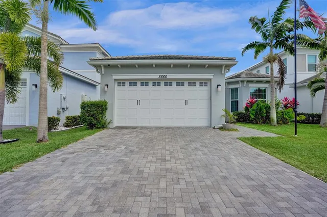 a view of a house with a yard and plants