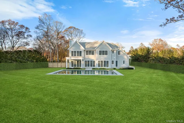 a view of a house with a big yard next to a house
