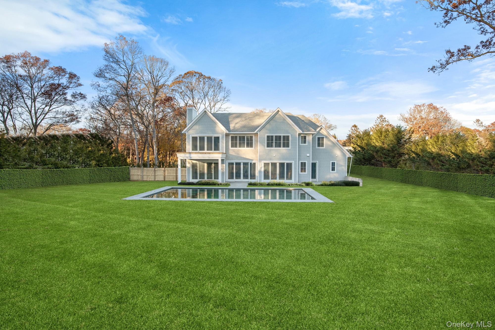 244 North Sea Mecox Road Southampton, NY 11968 - Photo 3 of 7 a view of a house with a big yard next to a house
