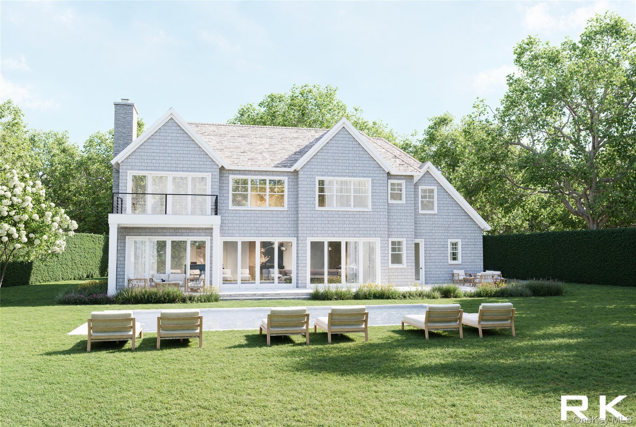 244 North Sea Mecox Road Southampton, NY 11968 - Photo 6 of 7 a front view of a house with a yard table and chairs