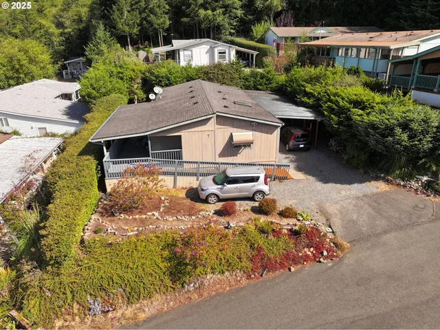 an aerial view of a house with yard swimming pool and outdoor seating