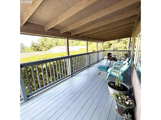 a view of a porch with furniture and wooden floor