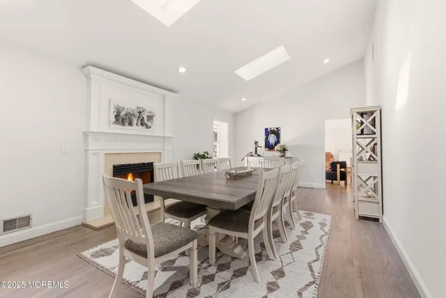 a living room with furniture a large window and wooden floor