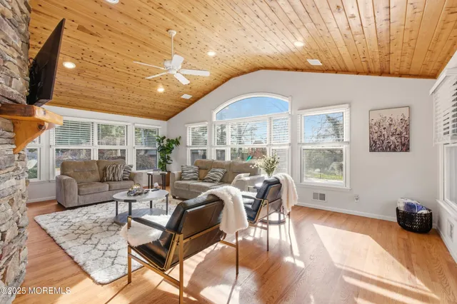 a living room with furniture fireplace and flat screen tv