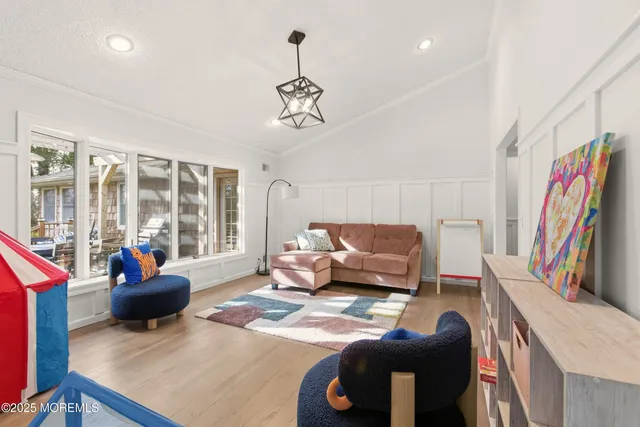 a view of a hallway with a livingroom and a bathroom with a sink