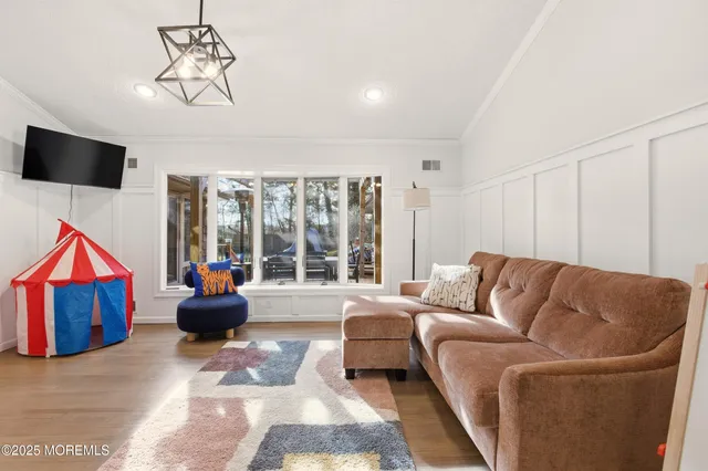 a spacious bedroom with a bed and wooden floor