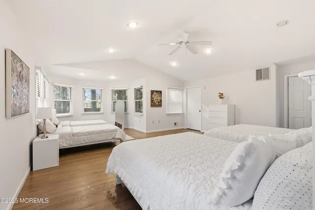 a spacious bedroom with two beds and a couch