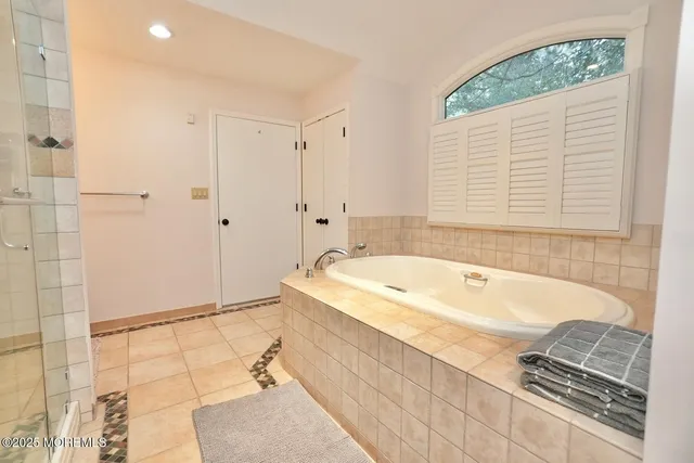 a bedroom with two beds and a large window