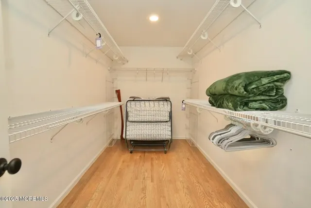 a bedroom with two beds and a large window