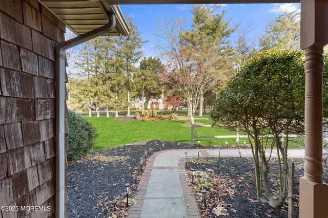 a hallway with white cabinets and wooden floor