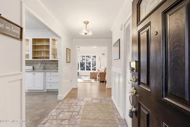 a living room with furniture and large windows