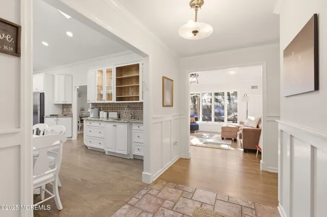 a large kitchen with kitchen island lots of counter space a sink appliances and a large window