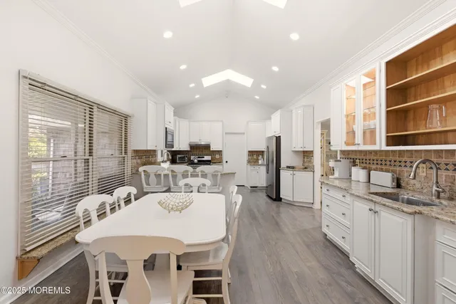a kitchen with stainless steel appliances kitchen island granite countertop a sink and cabinets
