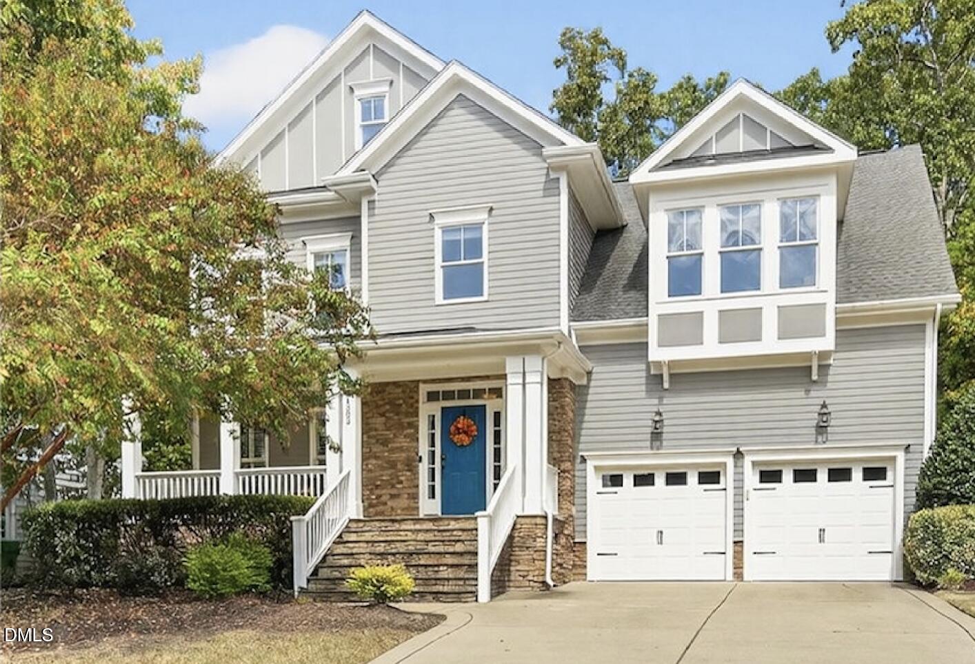 4305 Windscape Drive Apex, NC 27539 - Photo 1 of 50 a view of a white house with large windows and a small yard