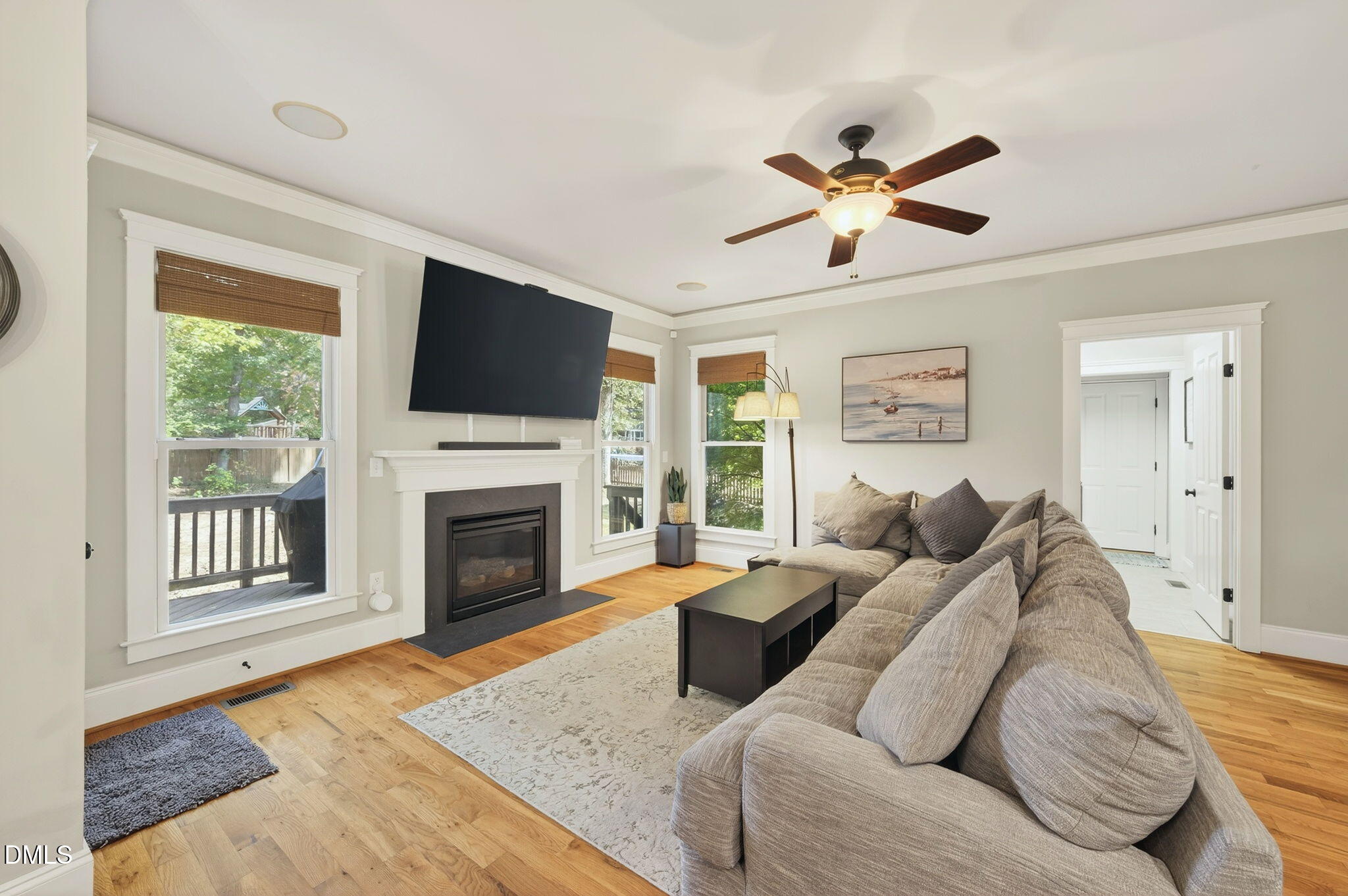 4305 Windscape Drive Apex, NC 27539 - Photo 16 of 50 a living room with furniture a fireplace and a flat screen tv