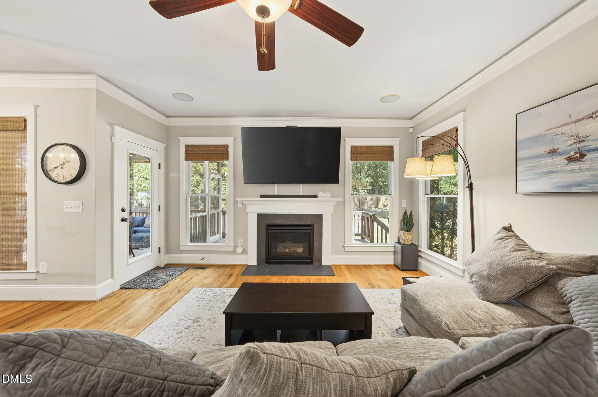 4305 Windscape Drive Apex, NC 27539 - Photo 21 of 50 a living room with furniture a fireplace and a flat screen tv