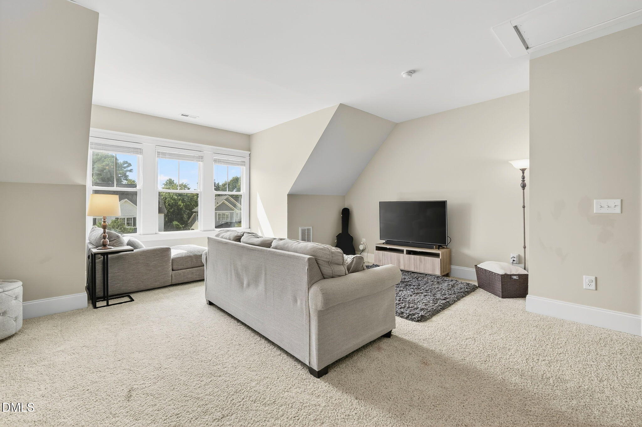 4305 Windscape Drive Apex, NC 27539 - Photo 26 of 50 a living room with furniture and a flat screen tv