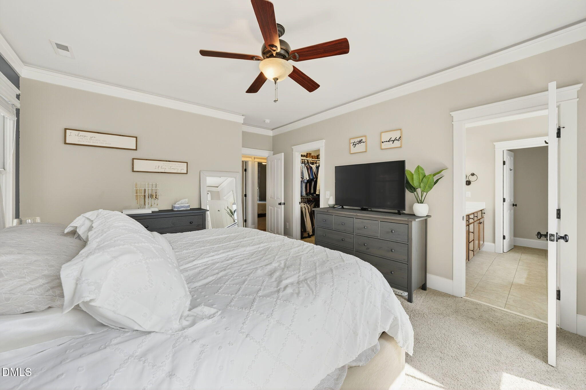 4305 Windscape Drive Apex, NC 27539 - Photo 31 of 50 a bedroom with a bed a flat screen tv and a chandelier