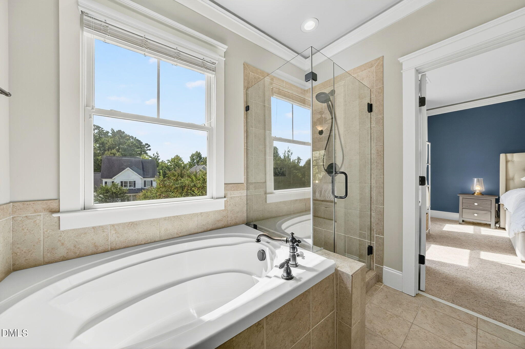 4305 Windscape Drive Apex, NC 27539 - Photo 33 of 50 a bathroom with a tub a sink and a large mirror