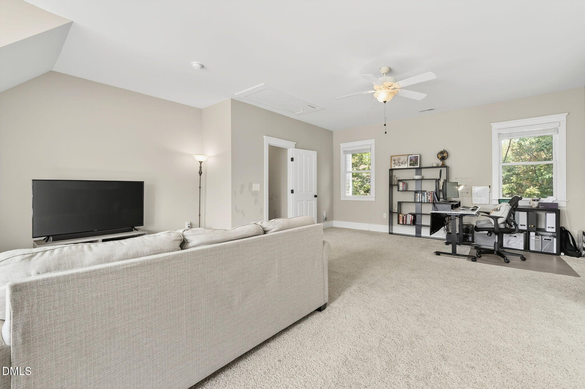 4305 Windscape Drive Apex, NC 27539 - Photo 36 of 50 a living room with furniture and a flat screen tv