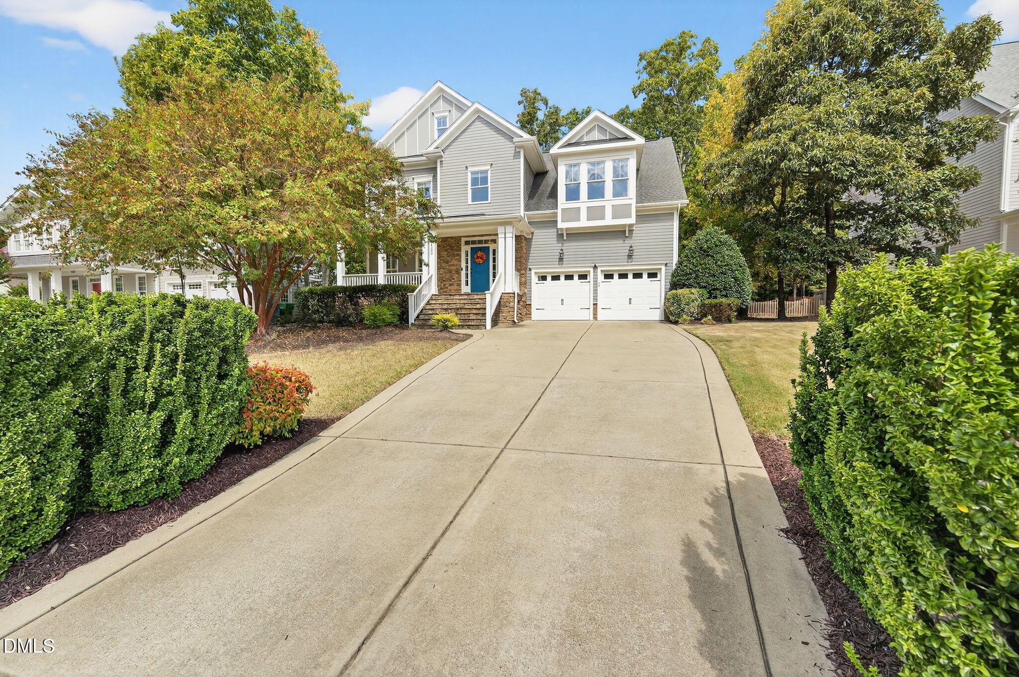 4305 Windscape Drive Apex, NC 27539 - Photo 50 of 50 a front view of a house with a yard and potted plants