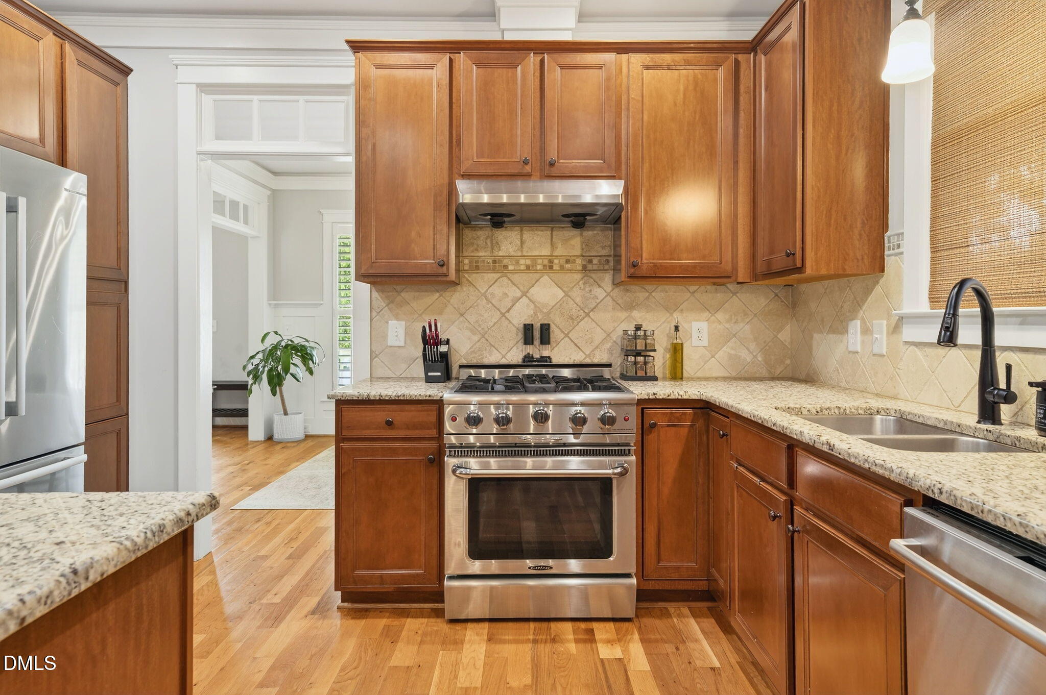 4305 Windscape Drive Apex, NC 27539 - Photo 10 of 50 a kitchen with stainless steel appliances granite countertop a stove a sink and a microwave