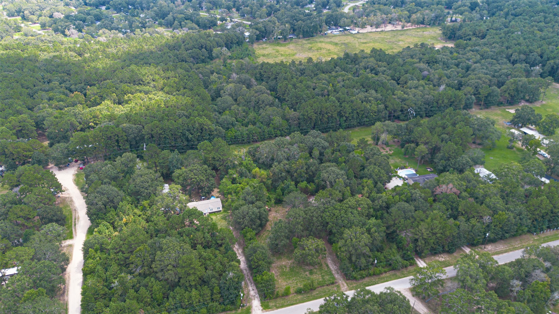 12297 Rebel Road Cleveland, TX 77327 - Photo 19 of 36 a view of a lake with a yard and mountain view