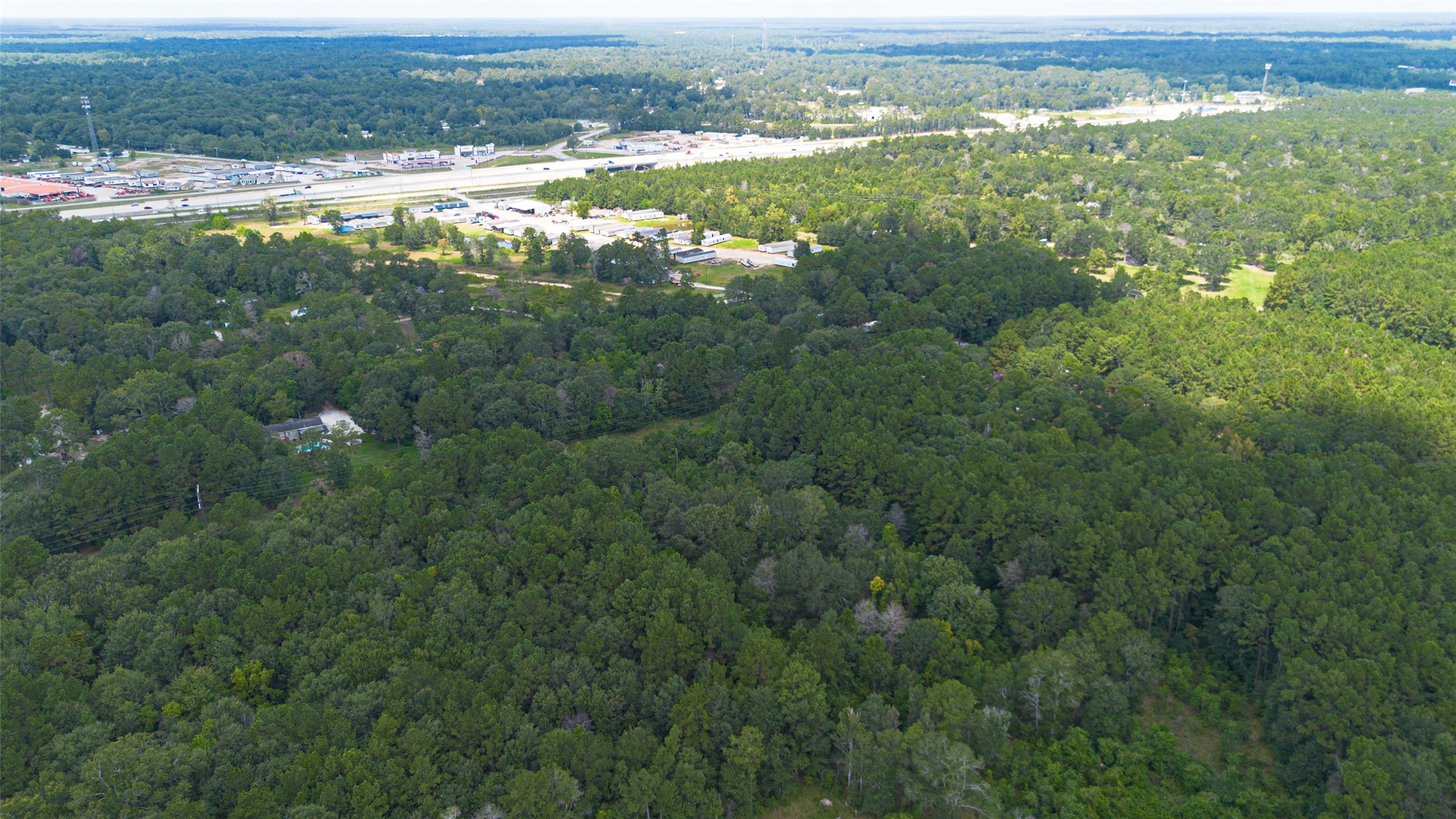 12297 Rebel Road Cleveland, TX 77327 - Photo 24 of 36 an aerial view of residential houses with outdoor space and trees