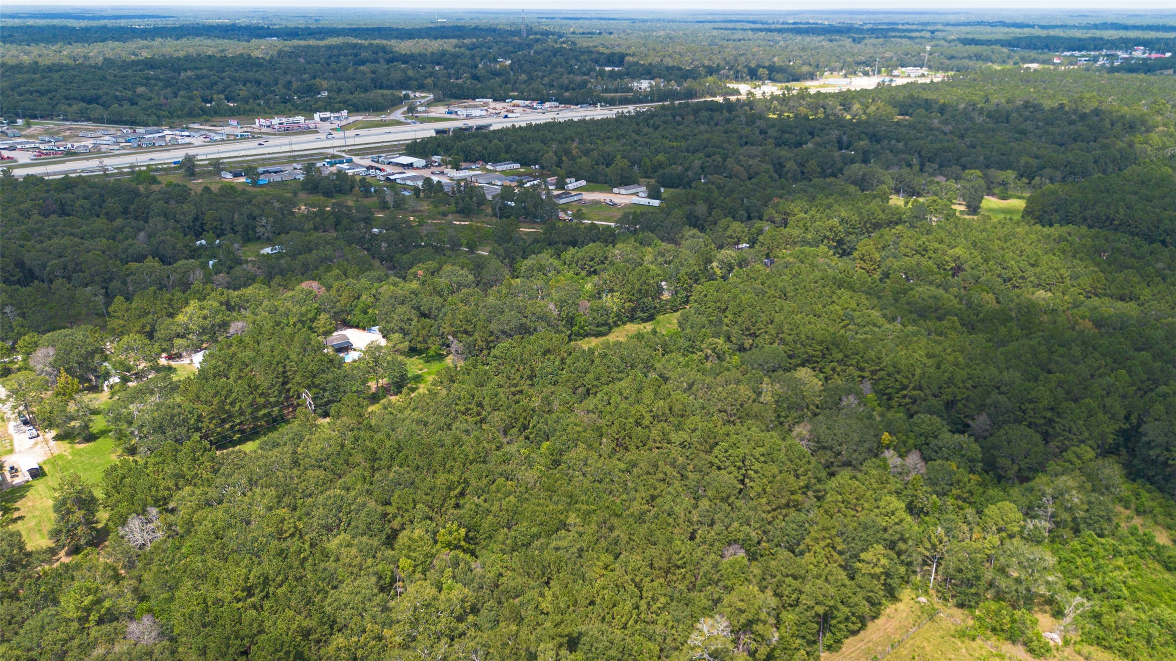12297 Rebel Road Cleveland, TX 77327 - Photo 33 of 36 a view of a lake with a city