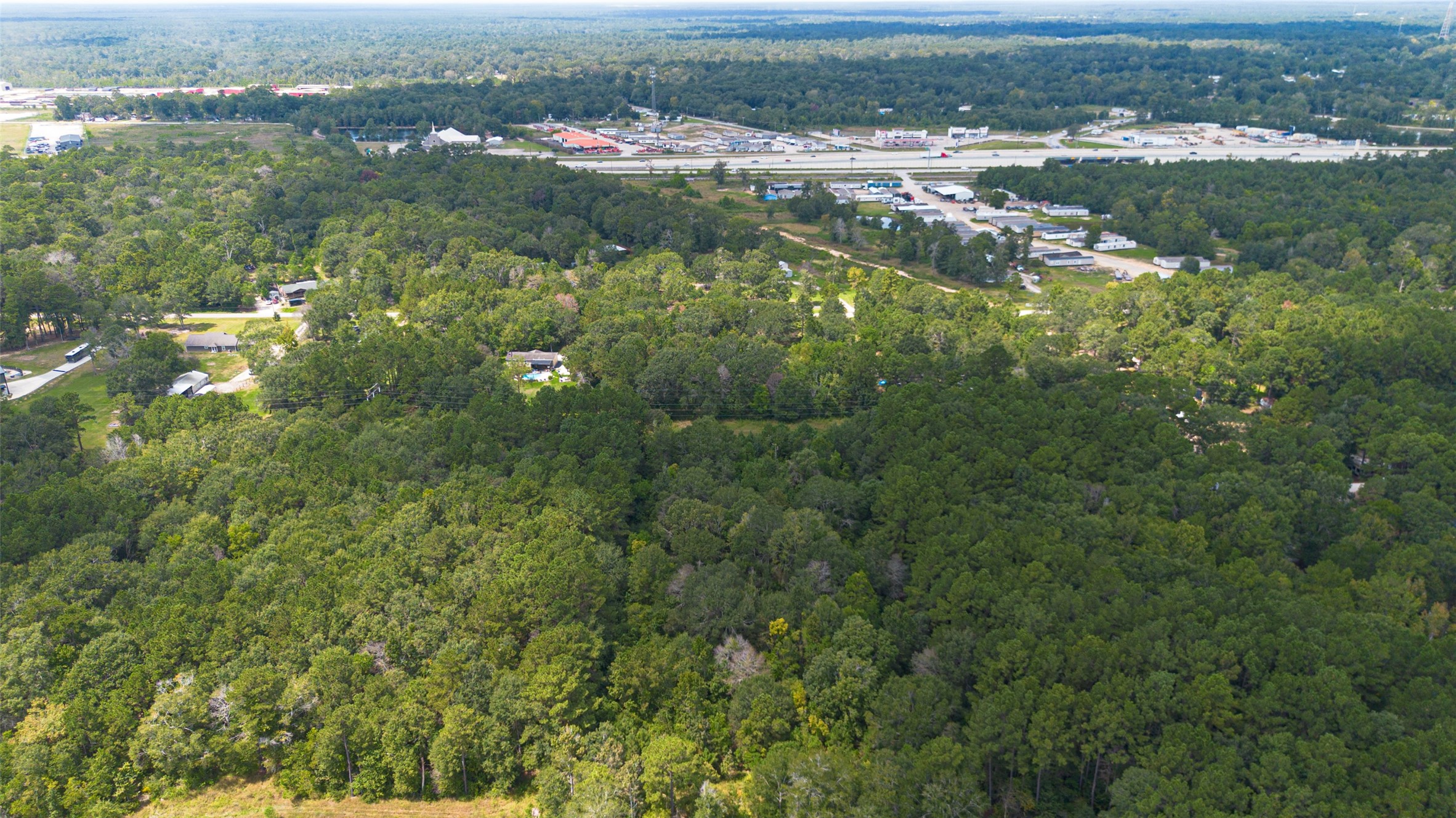 12297 Rebel Road Cleveland, TX 77327 - Photo 34 of 36 an aerial view of residential houses with outdoor space and trees
