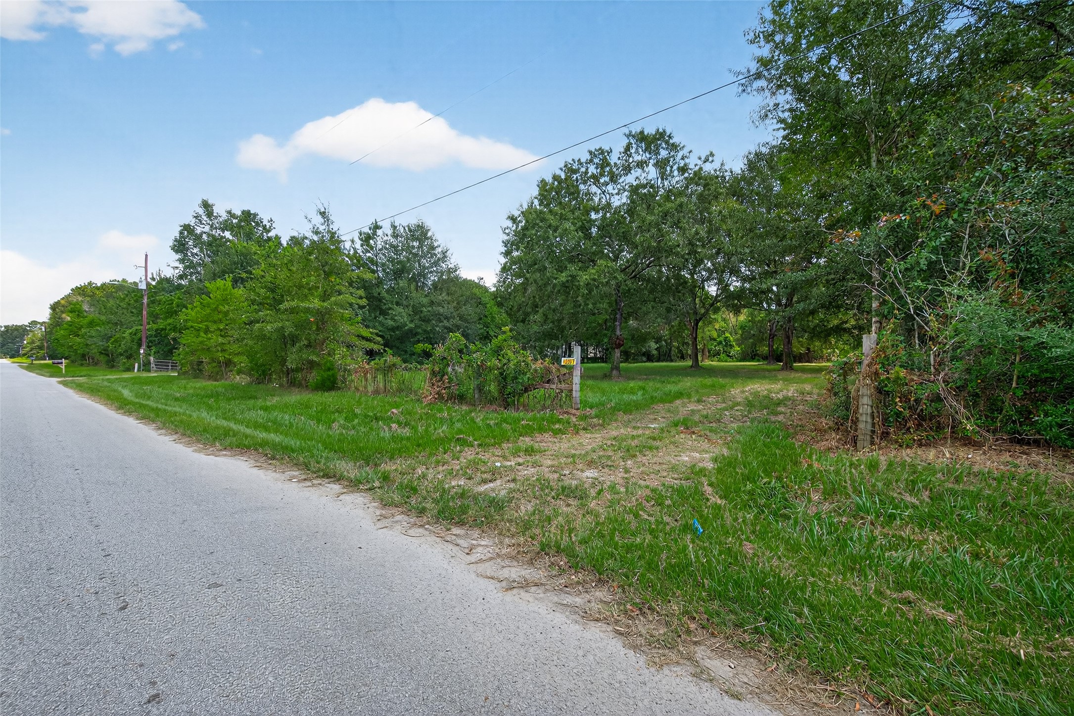 12297 Rebel Road Cleveland, TX 77327 - Photo 6 of 36 a view of a grassy field