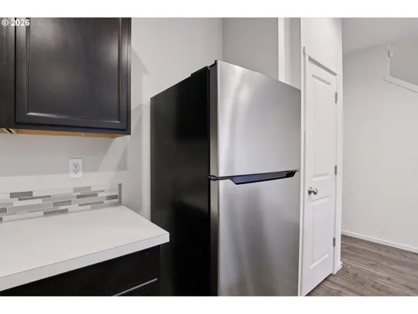 a kitchen with a refrigerator and a sink