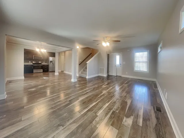 a view of a room wooden floor and a window
