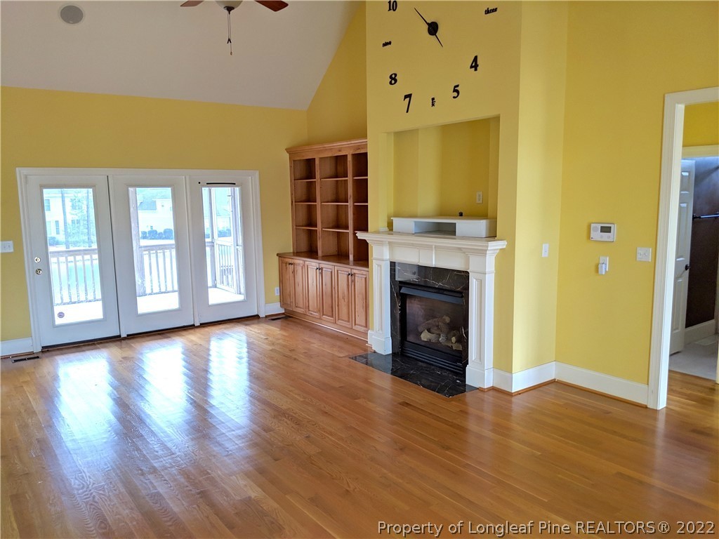 238 Falling Water Road Spring Lake, NC 28390 - Photo 4 of 7 an empty room with a fireplace and wooden floor